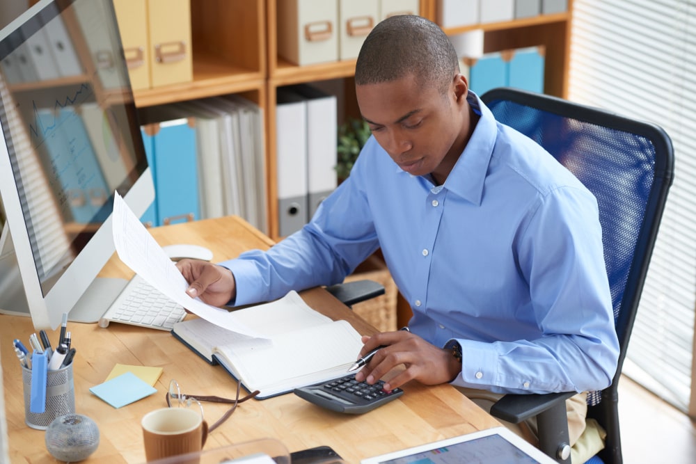 high-angle-view-male-accountant-checking-financial-document